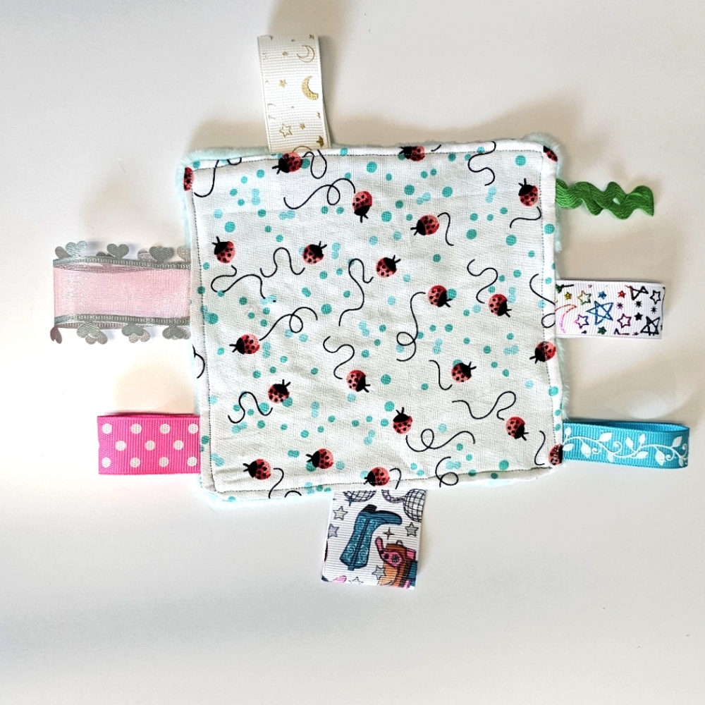 Baby sensory toy with tags